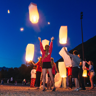 Families release wish lanterns into the night sky