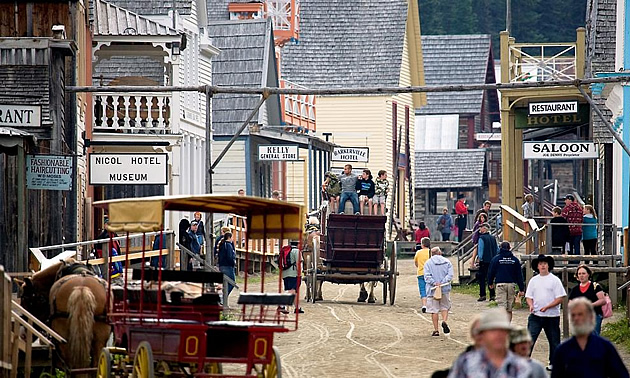 heritage town with horse drawn buggies and people in period costume