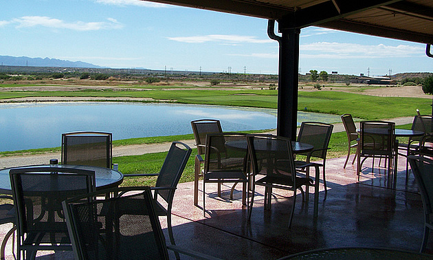 chairs on a patio overlooking the golf course