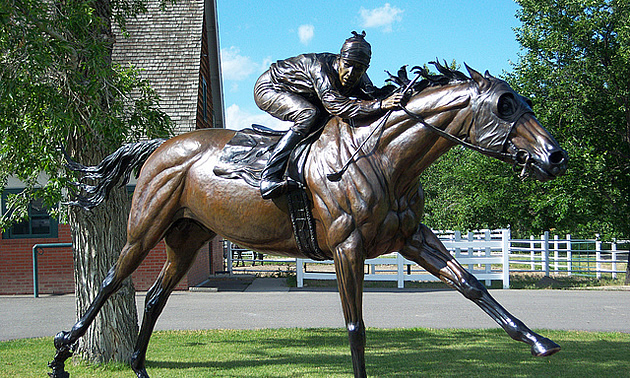 bronze statue of a jockey riding a horse