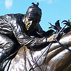 bronze statue of a jockey riding a horse