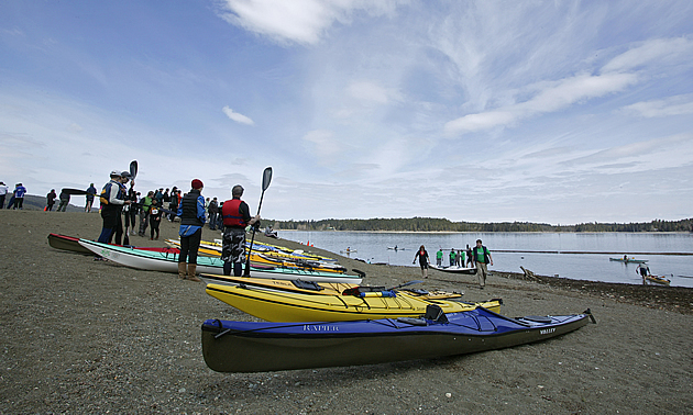 people getting ready to put boats in the water