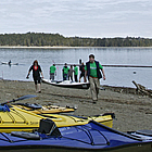 people getting ready to put boats in the water