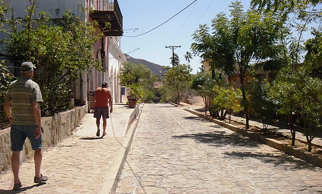 people walking down a cobblestone street