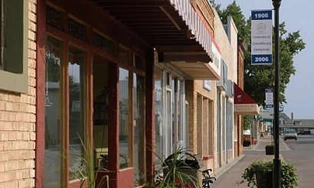 downtown with stores and a signpost