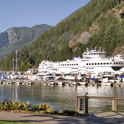 A cruise ship and sailboats are docked in Horseshoe Bay. 