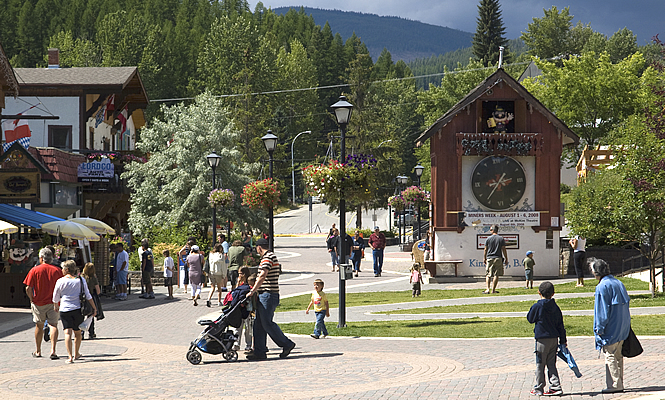 main street with people walking around a clock tower