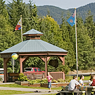 building with statue of a spirit bear and several flags in front