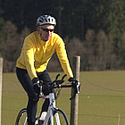 people riding bikes on a country road