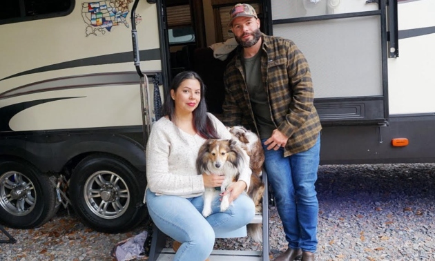 Lester Pozo, his wife and two sheltie dogs beside their RV