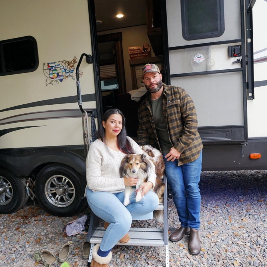 Lester Pozo, his wife and two sheltie dogs beside their RV