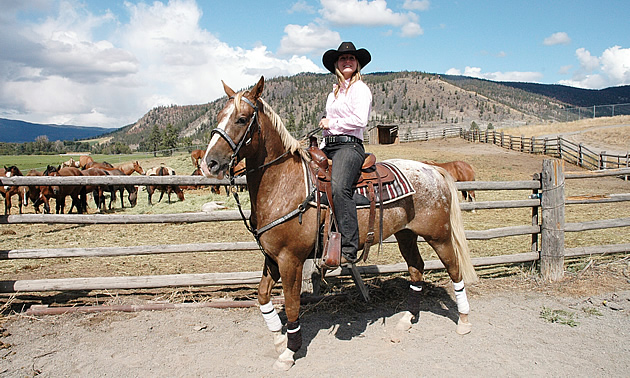 lady wearing a cowboy hat, sitting on a horse, near one of the camping areas near Merritt, BC