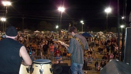 a musician looks out at the crowd in front of him.