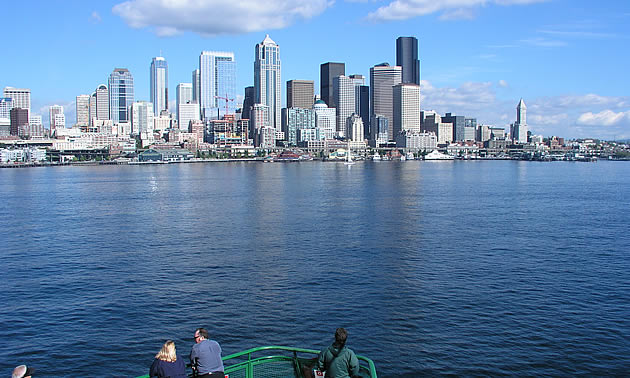 ferry crossing water to a city scape