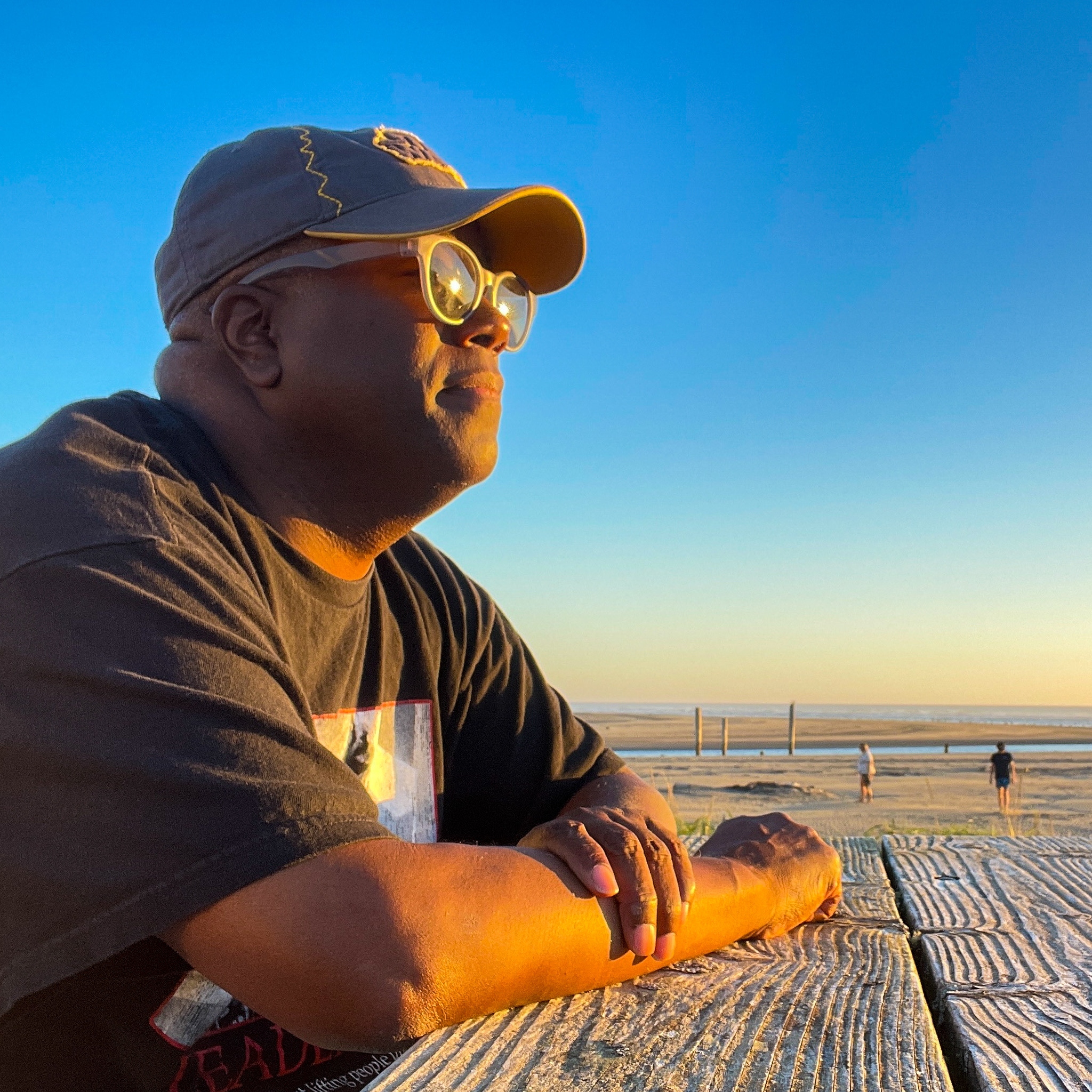 David Lee looking out at the horizon, wearing a baseball cap and t-shirt.