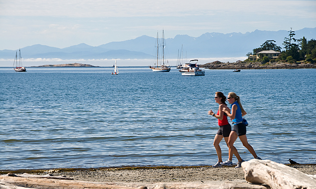 two women running along a beach