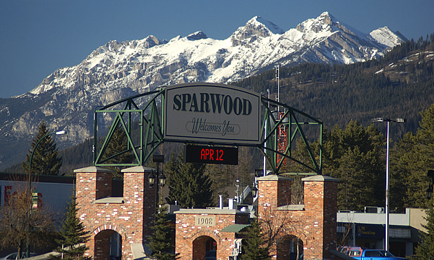 sign entering town that says Sparwood, mountains in background