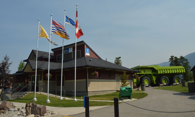 Shown is the front entrance of the Sparwood Chamber of Commerce with the Titan truck beside it.