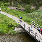 people riding bikes over a bridge